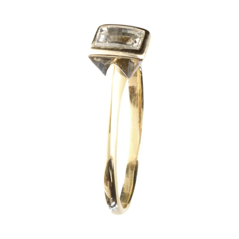 Gold ring with a diamond on a white background