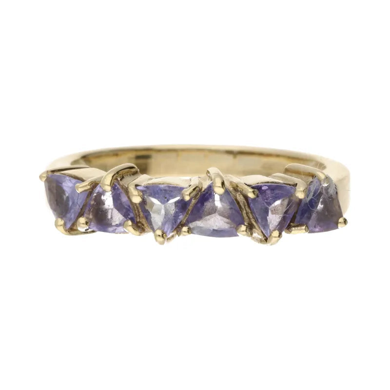 Gold ring with triangular purple gemstones on a white background