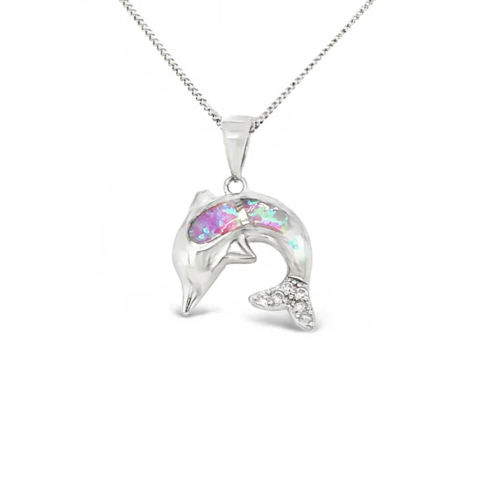 Dolphin-shaped pendant with colorful gemstone on a white background